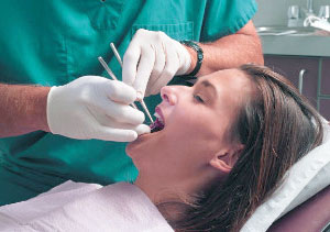 A woman appears fully relaxed during a dentist visit.