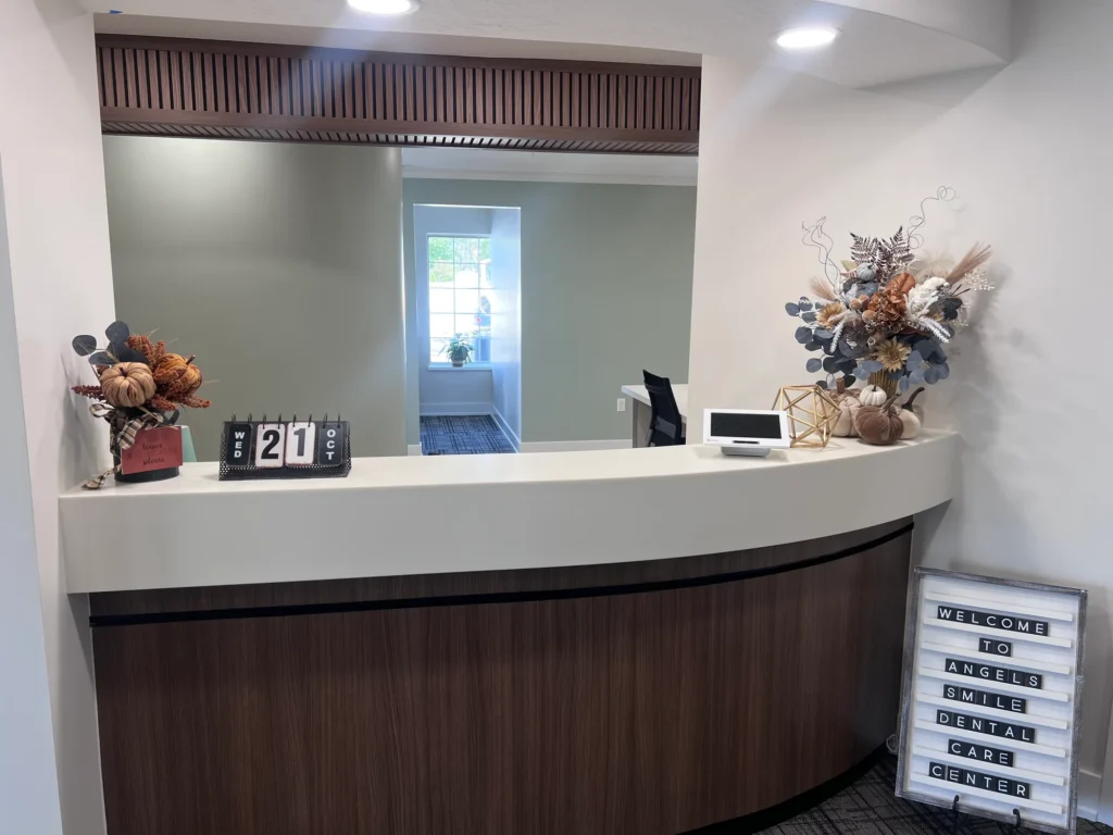 Front desk with a welcome sign for Angel's Smile Dental Care Center