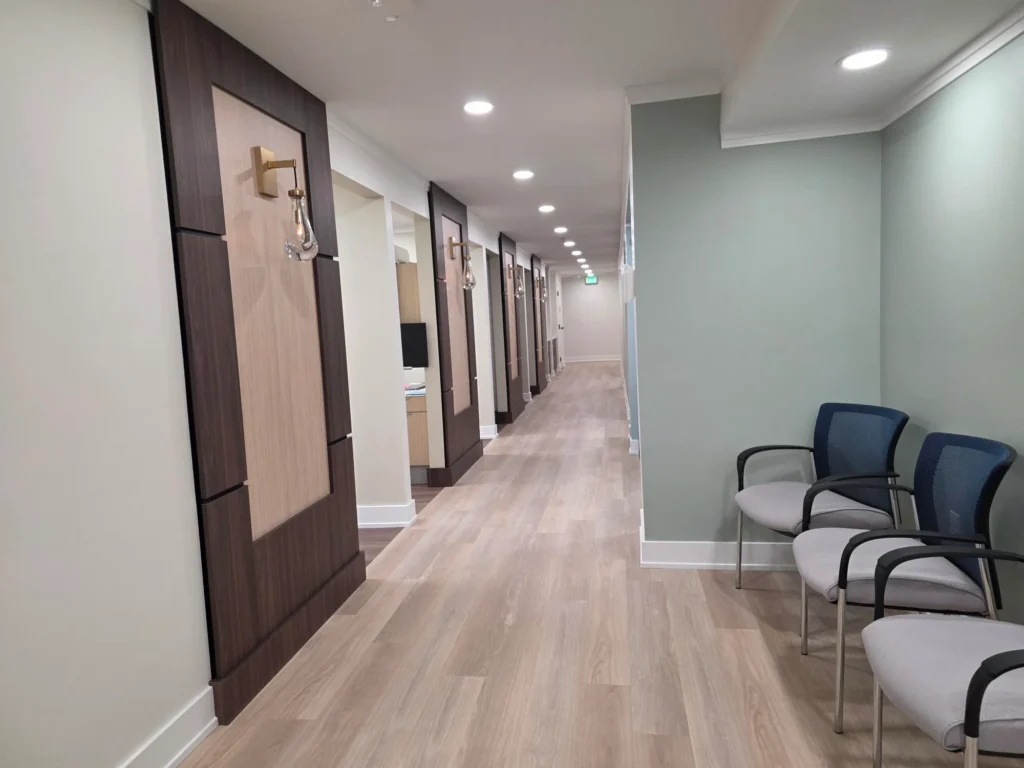 Hallway to the treatment rooms with chairs along the wall