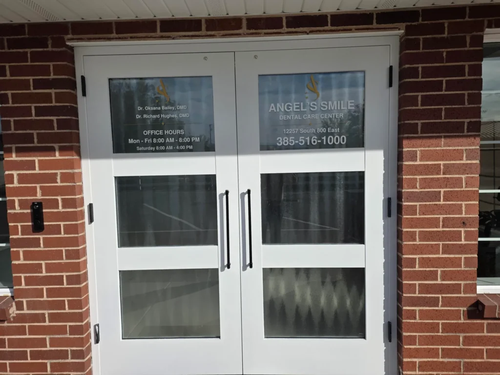Front entrance doors with the office hours and phone number on the glass