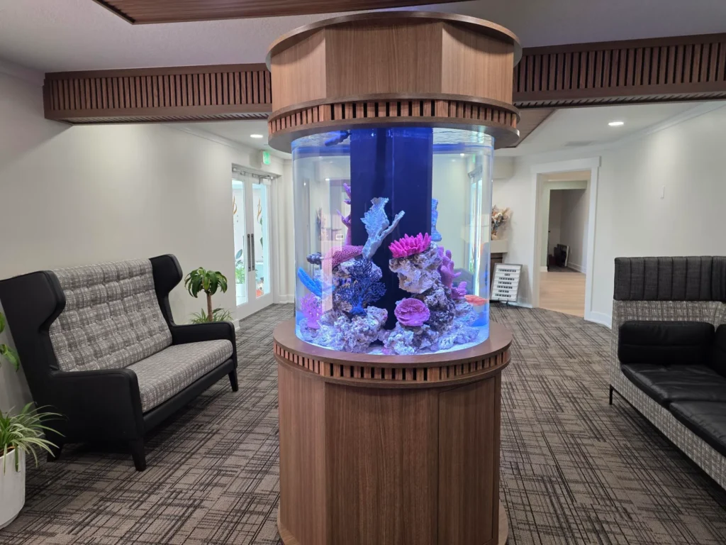 Round aquarium with coral in the center of the waiting room
