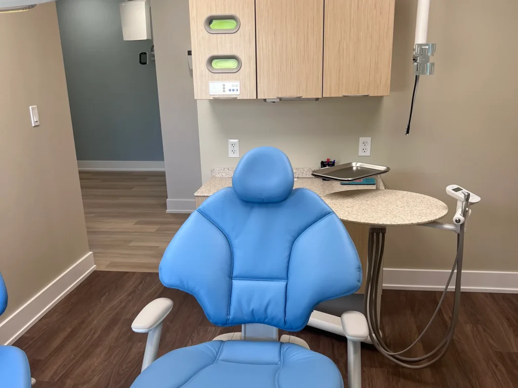 Treatment room with a blue dental chair